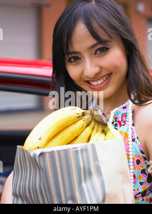 Woman carrying grocery bags, smiling Stock Photo