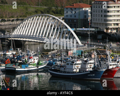 The bridge and fishing boats in the harbour at Ondarroa Basque fishing port in Spain Stock Photo