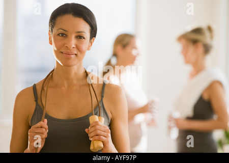 African woman holding jump rope Stock Photo