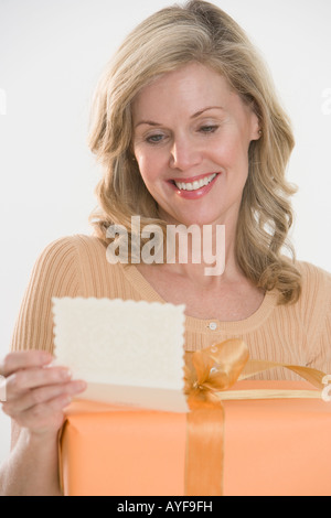Woman reading card on gift Stock Photo