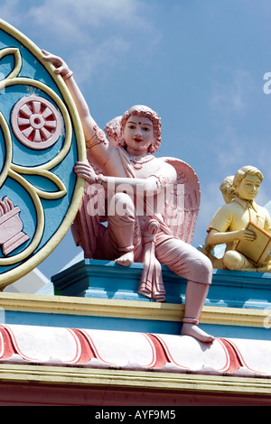 Cherub statue holding sarva dharma symbol on a concrete archway that spans the road in the town of Puttaparthi, Andhra Pradesh, India Stock Photo