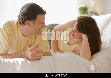 Couple talking on bed Stock Photo