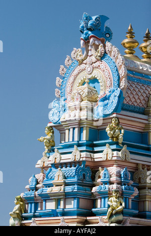 Indian gopuram temple architecture against a bright blue sky, in the South Indian town of Puttaparthi Stock Photo