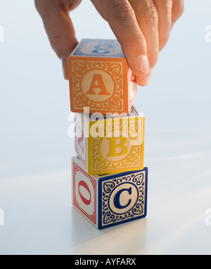 Man reaching for ABC blocks Stock Photo