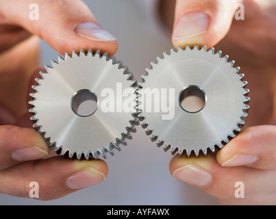 Man holding cog wheels Stock Photo