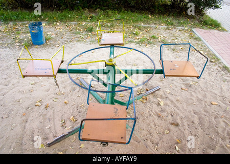 Antiquated but practical merry-go-round in small park. Lodz Central Poland Stock Photo