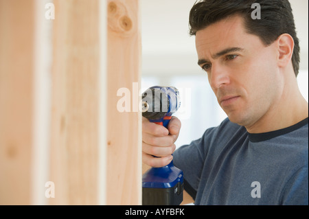 Man using cordless drill Stock Photo