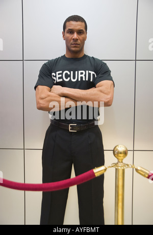 African male bouncer, velvet rope Stock Photo