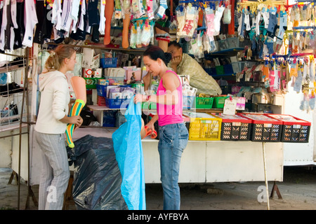 Women packaging mannequins socked legs. Balucki Rynek Market Lodz Central Poland Stock Photo