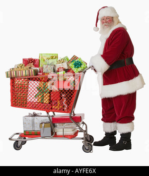 Santa Claus pushing shopping cart full of gifts Stock Photo