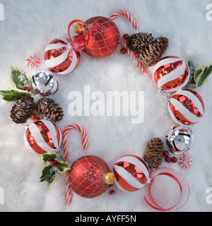 Wreath of Christmas ornaments in snow Stock Photo