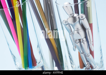 Colour Pencils and Mannikin in Glass Bottles Stock Photo