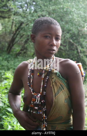 Africa Tanzania Lake Eyasi Portrait of a young Hadza mother with her baby strapped to her back A small tribe of hunter gatherers Stock Photo