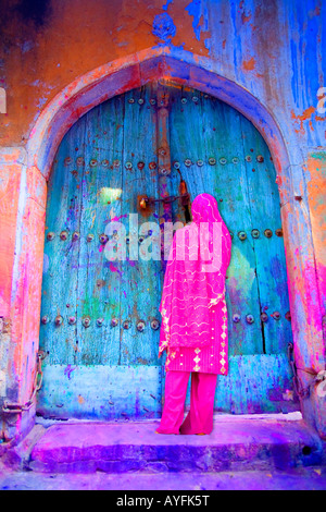 Woman in Old Delhi by a colorful door, India Stock Photo