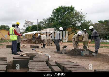 Construction workers discussing project while building village community centre for benefit of local village, Ghana, West Africa Stock Photo