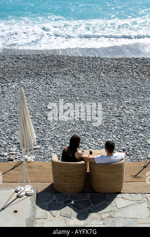 a young couple enjoying sunny afternoon on the beach in Nice, South France Stock Photo