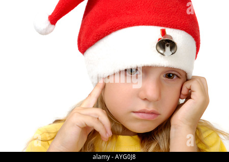 Little sad girl in a red christmas hat Stock Photo