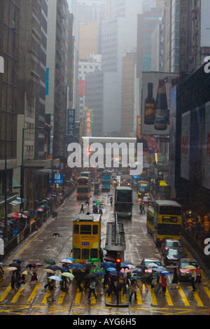 Street Crossing in the Rain, Many Umbrellas, Downtown Hong Kong Stock Photo