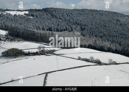 Farmhouse fields and Macclesfield Forest in the snow view from Teggs Nose Country Park Stock Photo