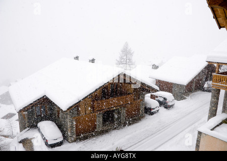 Alpine chalets in a snowstorm Sainte Foy France Stock Photo