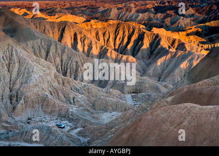 Last light over Badlands of Anza Borrego Desert State Park with SUV in foreground in southern California along Mexican border Stock Photo