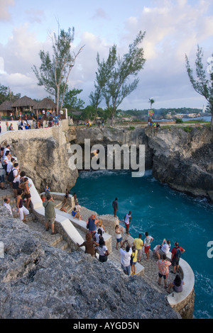 Jamaica Negril Ricks Cafe Cliff Diver jumping from a Tree crowd Stock Photo