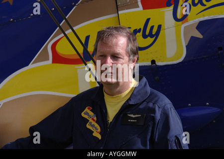 Vic Norman standing by an Utterly Butterly Stearman biplane Stock Photo