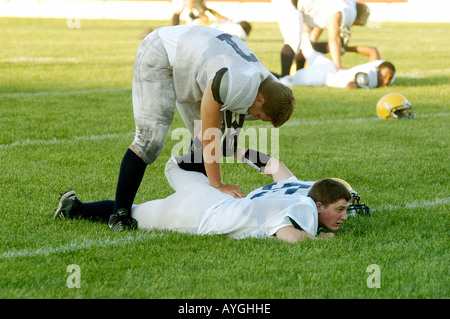 Football players warm up with exercises before playing in a game Stock Photo