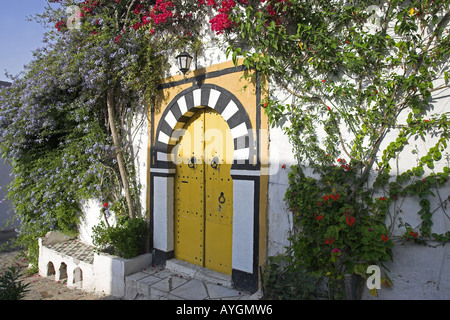 Attractive black stud double yellow doors with in black and white archway Sidi Bou Said village Tunisia