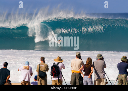 Surfer on a classic big barreling surfing wave at the Banzai Pipeline Rip Curl contest on the North Shore of Oahu Hawaii Stock Photo