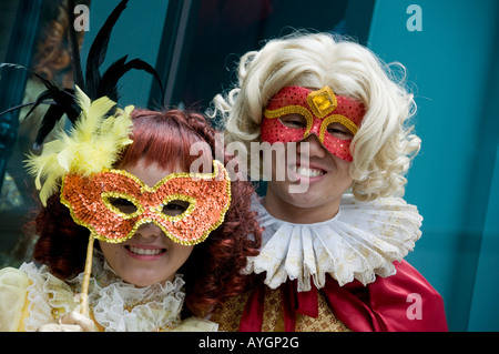 Two people in Mardi Gras costumes and masks Stock Photo