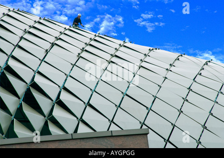 Roof tiles and construction worker working on top of Esplanade theaters in Singapore Stock Photo