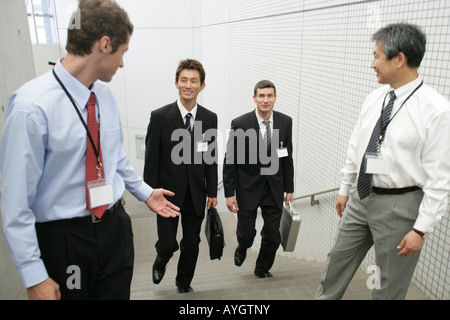 Four business men going up staircase Stock Photo