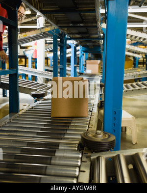 Boxes on conveyor belt in warehouse Stock Photo