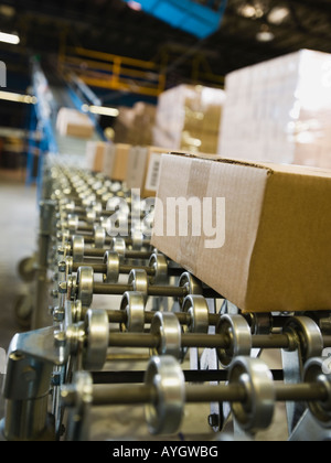 Packages on conveyor belt in warehouse Stock Photo