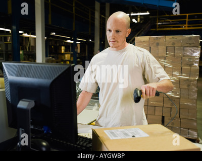 Warehouse worker scanning package Stock Photo