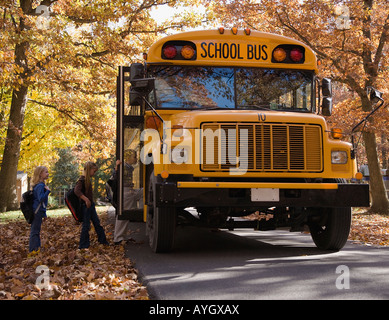 Children getting on school bus Stock Photo