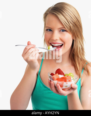 Woman eating fruit salad Stock Photo