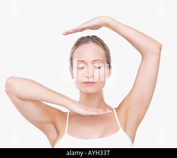 Woman framing face with hands Stock Photo