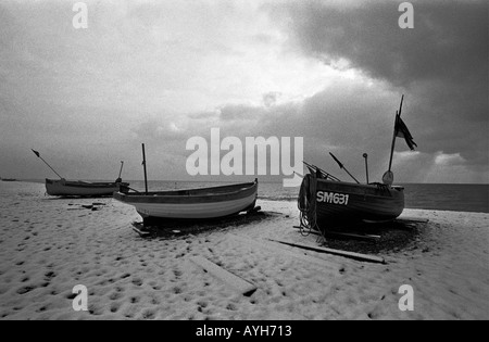 Fishing boats dusted with snow on Brighton beach Stock Photo
