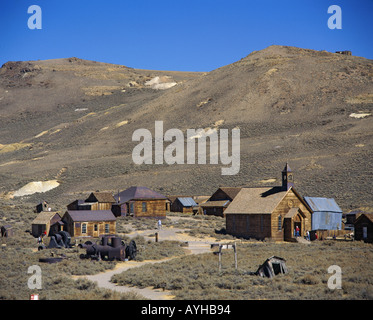 Scenic view of 1880’s old gold mining ghost town at foot of dry semi desert hills at Bodie State National Park California USA Stock Photo