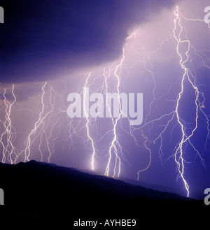 Close striking lightning bolts during summer a monsoon storm on the Rincon Mountains in Tucson, Arizona, United States. Stock Photo