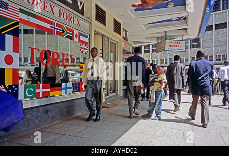 AFRICA KENYA NAIROBI Street scene in downtown Nairobi Money change businessmen modern buildings beggers Stock Photo