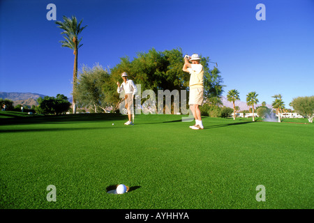 Senior citizens putting on green in Palm Springs California Stock Photo