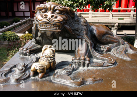 Bronze statue of a lion dog and her cub in the famous,historic Tiger Hill Pagoda Gardens in Suzhou China Stock Photo