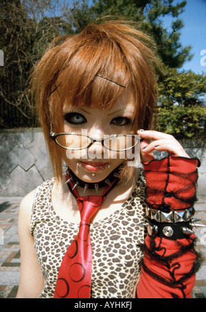 Teenage girl with unusual contact lenses dressed for cos-play coz-play on Jingubashi Bridge, Harajuku, Tokyo, Japan. Stock Photo