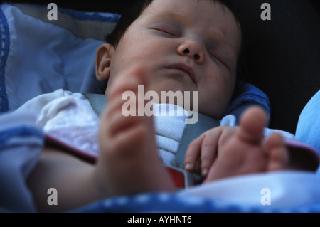 4 months old baby girl sleeping in a maxicosi Stock Photo