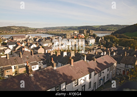 CONWY NORTH WALES UK November Looking across the towns roof tops to the River Conwy Edward 1s Castle and the Conwy Bridge viewed from town walls Stock Photo