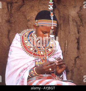 Young Maasai woman making beaded jewellery, Amboseli National Park, Kajiado District, Rift Valley Province, Republic of Kenya Stock Photo