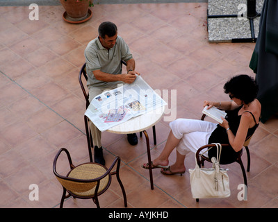 Palermo Sicily Italy Genoardo Park Hotel Reading Newspaper on Terrace Couple Sitting at Table Stock Photo